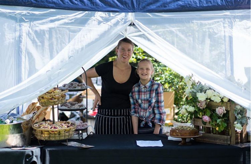 Photograph of a woman and a girl at a market stall